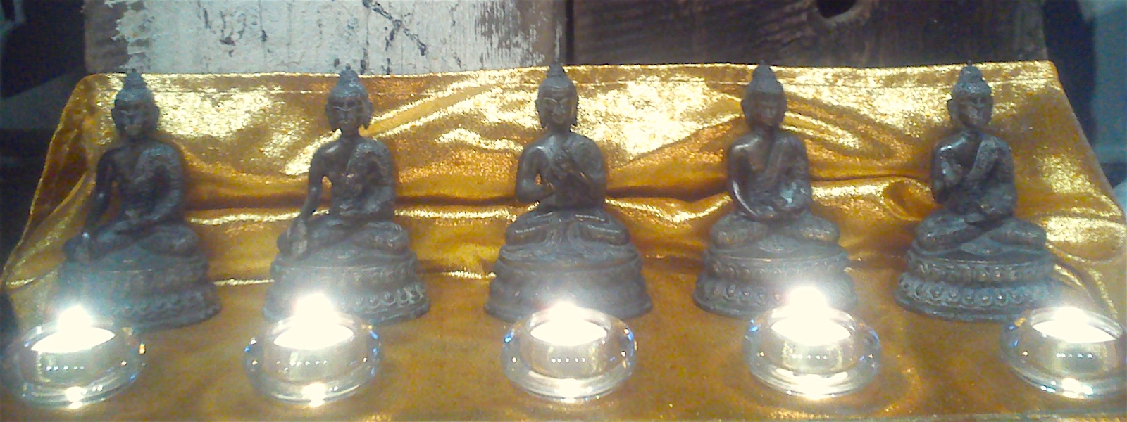 Row of Buddhas and candles